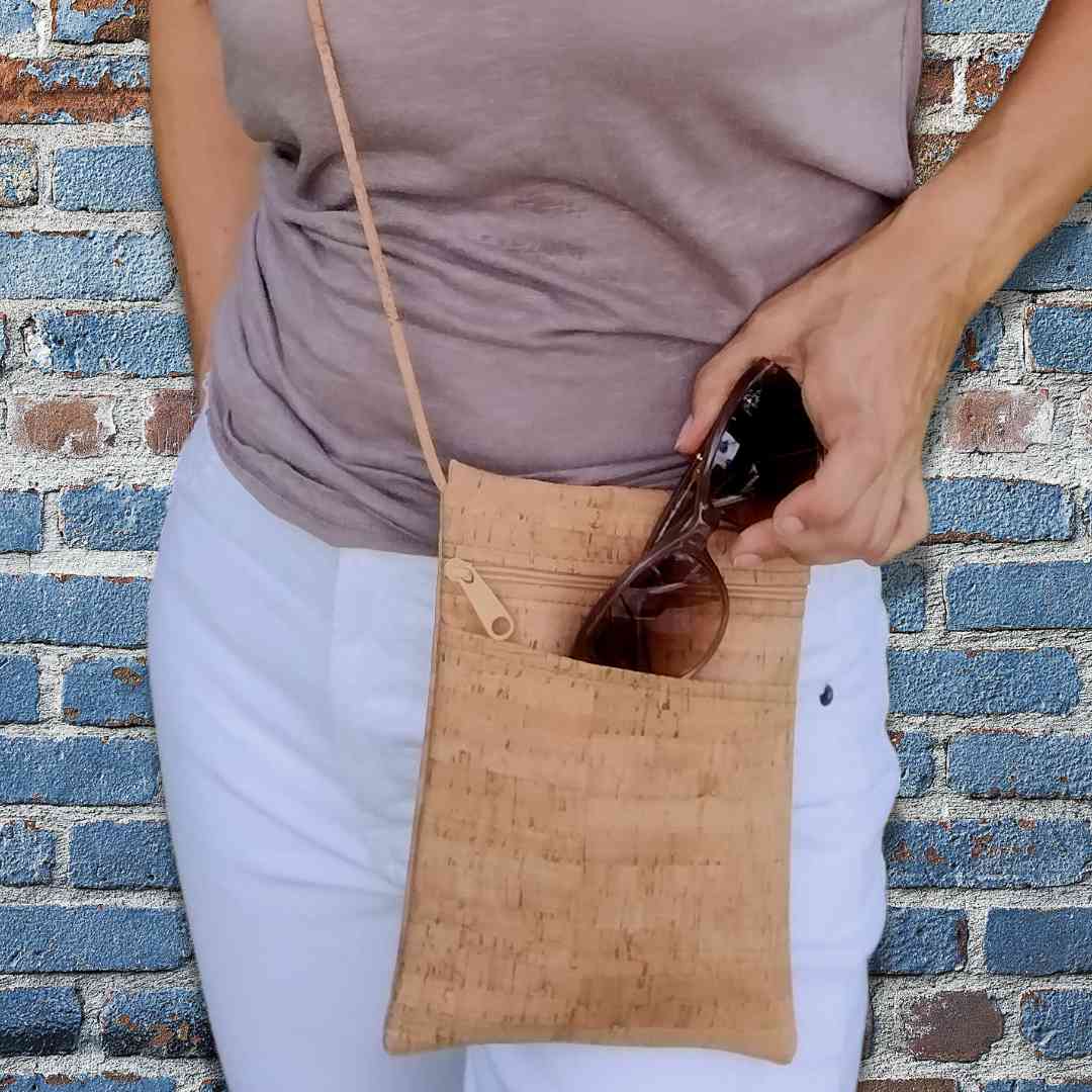 Close-up of the Be Lively Mini Crossbody Bag's adjustable cork leather strap connection showing textured vegan material and