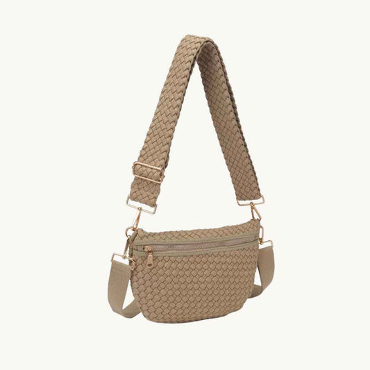 A beige woven vegan crossbody bag with a matching woven shoulder strap and gold-tone hardware, shown against a plain off-white background.