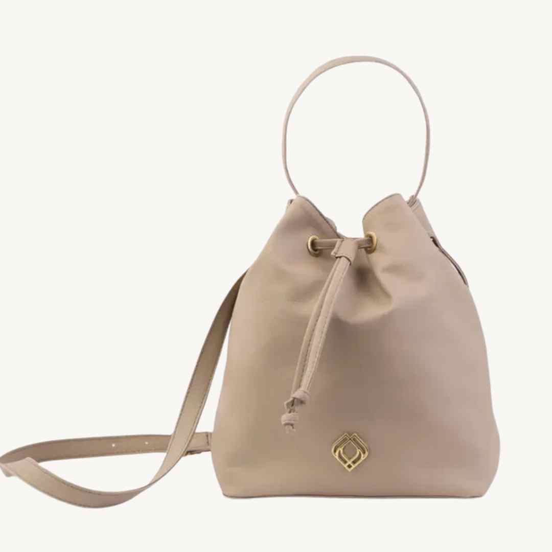 Close-up of the vegan corn leather bucket bag’s adjustable strap clasp and textured material detail from a front angle.