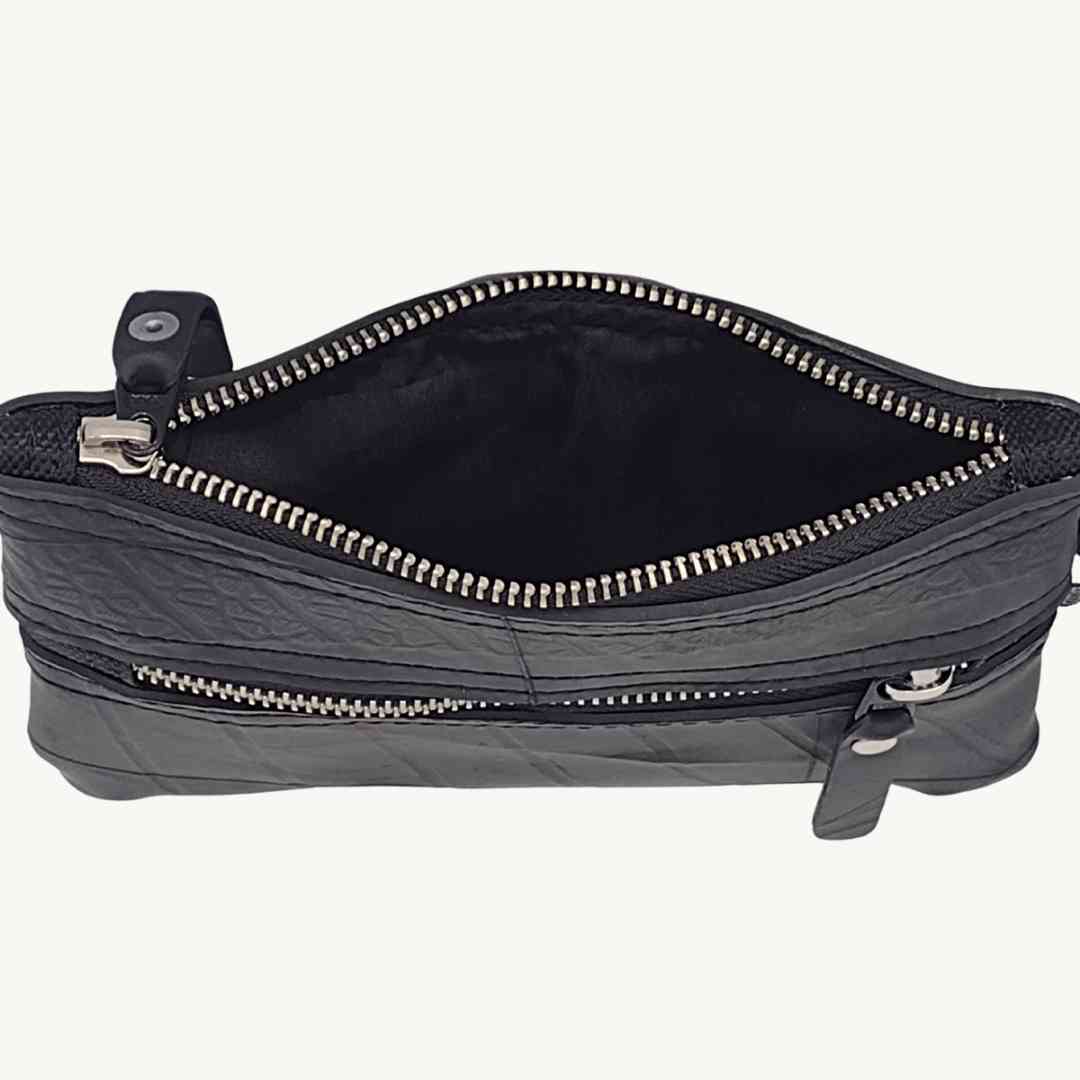 Close-up of the Erin Wallet’s textured upcycled vegan fabric edge detailing on zip closure against a neutral background.