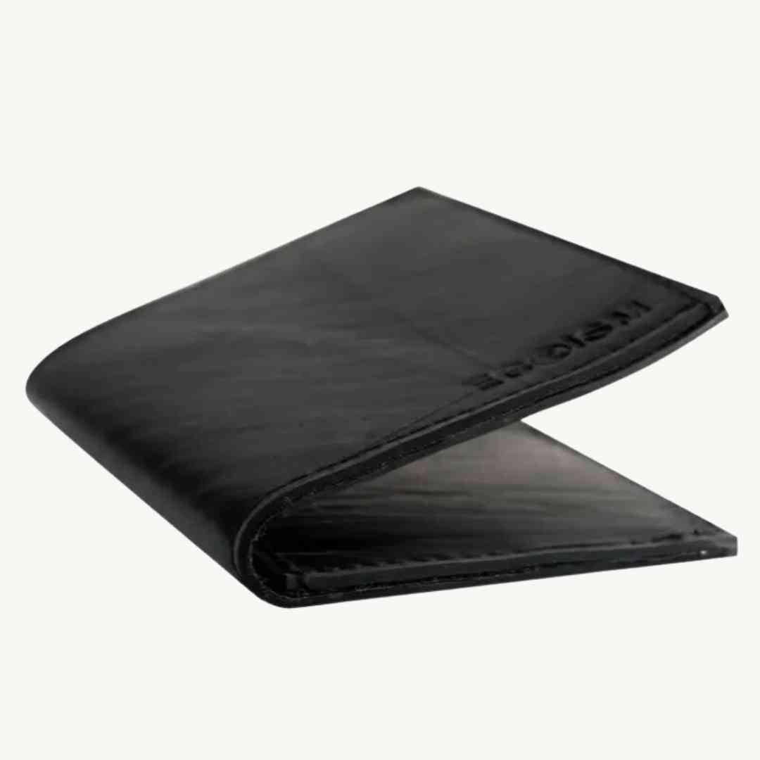 Close-up of the vegan belt's textured faux leather surface, showcasing precise stitching and smooth, matte finish from a