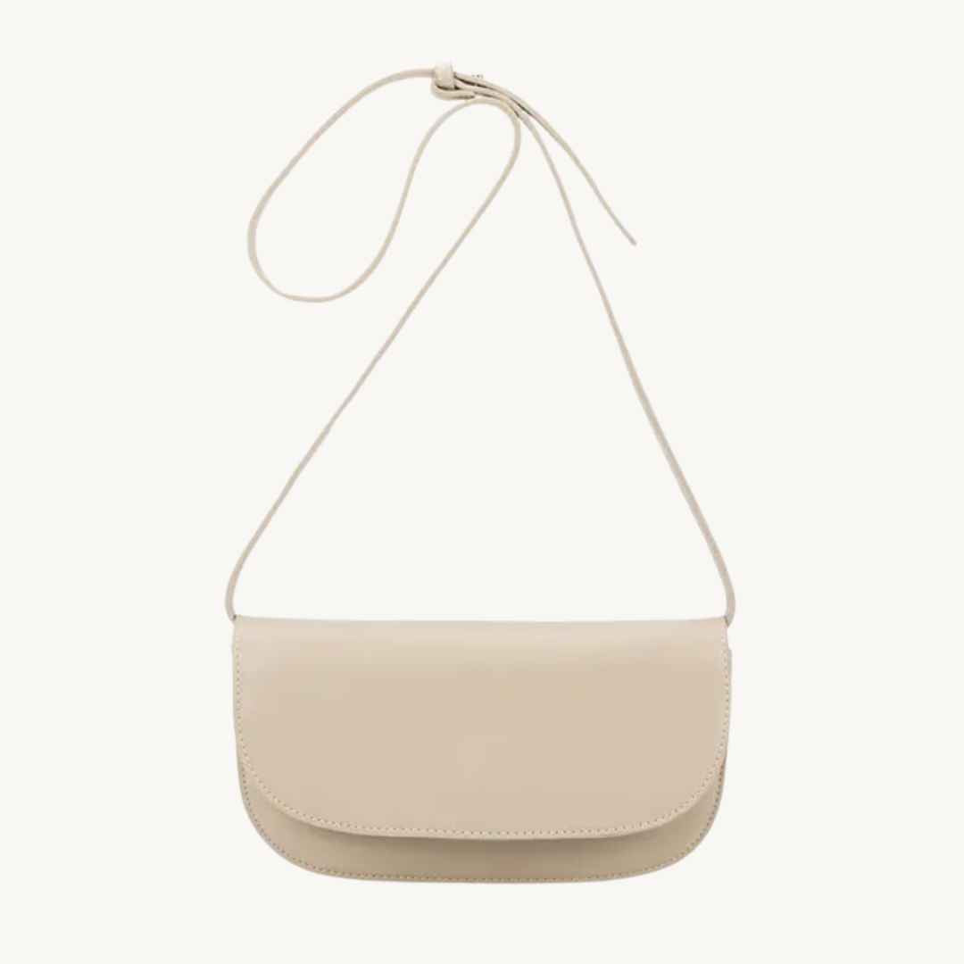 Close-up of the black recycled vegan leather strap's textured surface and silver hardware accent on the Inez convertible