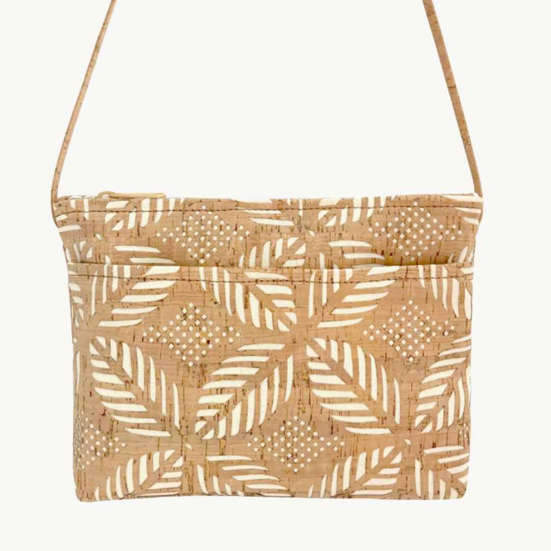 Close-up of the Palm Cut Cork Crossbody Bag’s vegan cork texture and slim wristlet strap detail from a front angled view.