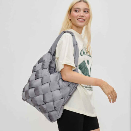 Gray woven vegan handbag made of recycled nylon being held