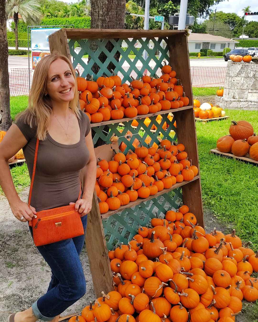 Close-up of the Iris cork leather crossbody bag’s textured vegan material with subtle embossed logo detail, showing