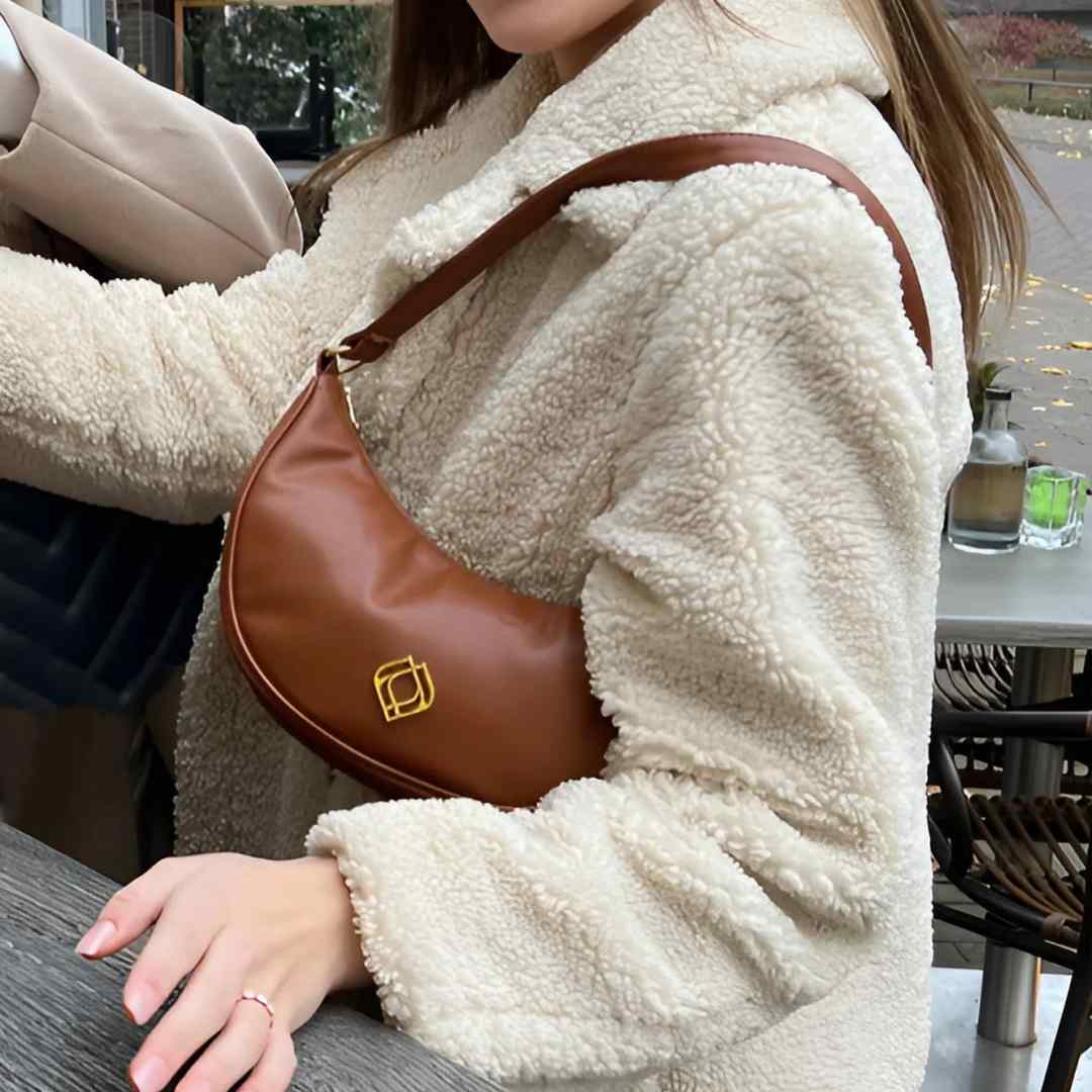 Close-up of the wine-colored vegan cactus leather exterior highlighting textured surface and subtle stitching details.