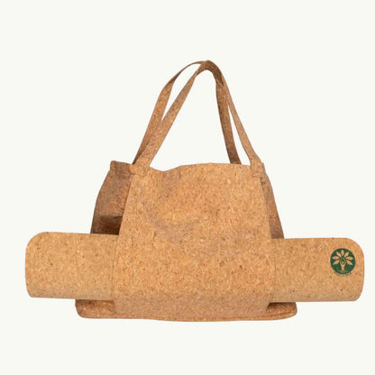 Close-up of the cork yoga mat's textured surface with embossed branding, highlighting its natural grain and thickness