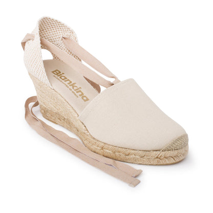 Beige wedge sandal with jute sole on a white background