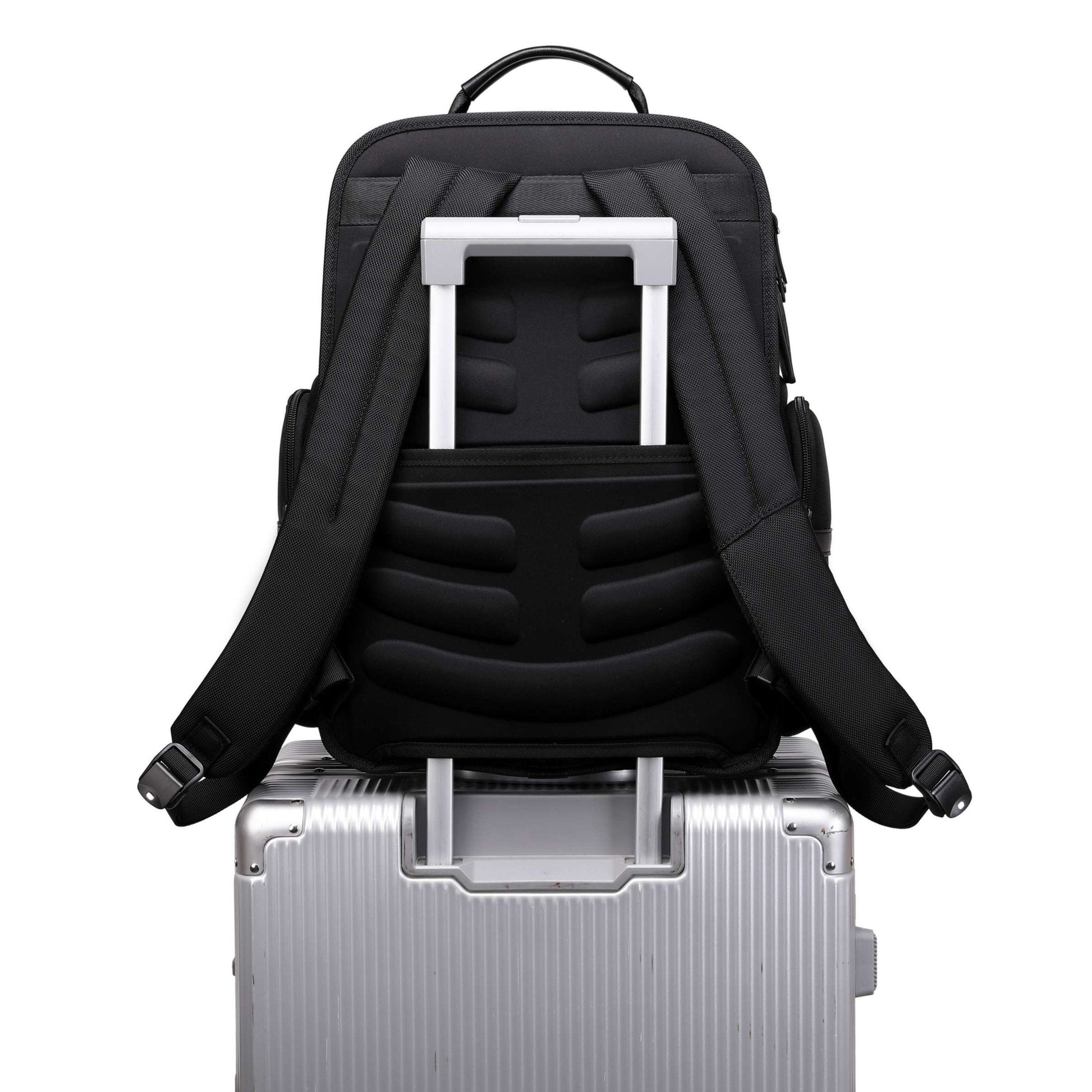 black vegan leather backpack for work on a suitcase
