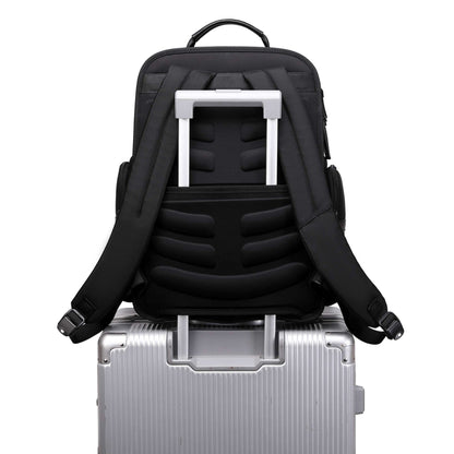 black vegan leather backpack for work on a suitcase