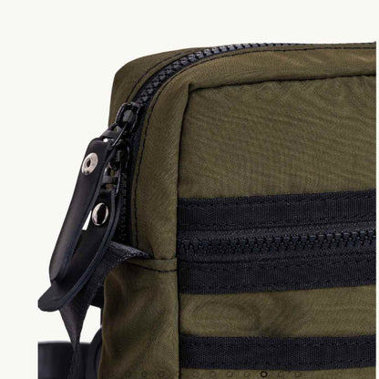 Close-up of the Major Vegan Crossbody Reporter Bag's textured upcycled rubber surface highlighting rugged, military-inspired