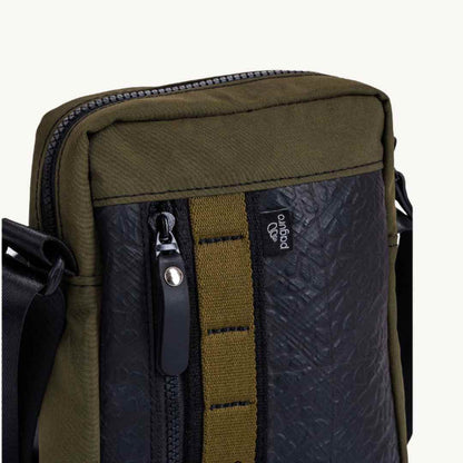 Close-up of the bag’s sturdy military canvas strap attachment with reinforced stitching and upcycled rubber accents.