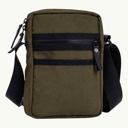 Close-up of the bag's durable military canvas strap attachment and rugged rubber detailing at the corner.