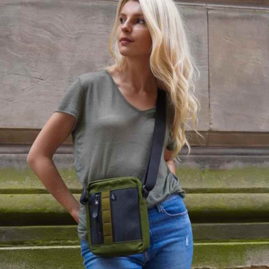 Close-up of the bag’s military canvas strap attachment featuring rugged stitching and upcycled rubber accents at an angled