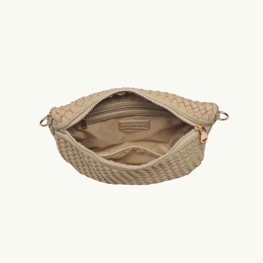 An open woven vegan leather bag in a light beige/tan color, showing its interior lining and gold-tone hardware, set against a plain off-white background.