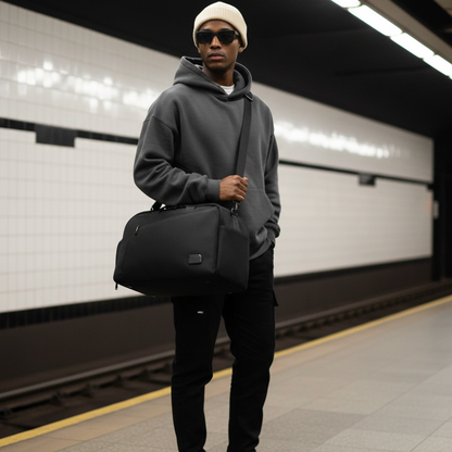 man holding a black duffle bag