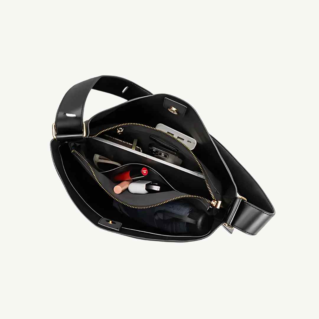 Close-up of black vegan suede tote bag handle detailing, showing textured surface and reinforced stitching at the top edge.