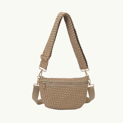 A woven crossbody bag vegan in a light tan/beige color with a matching woven strap and rose gold-tone hardware