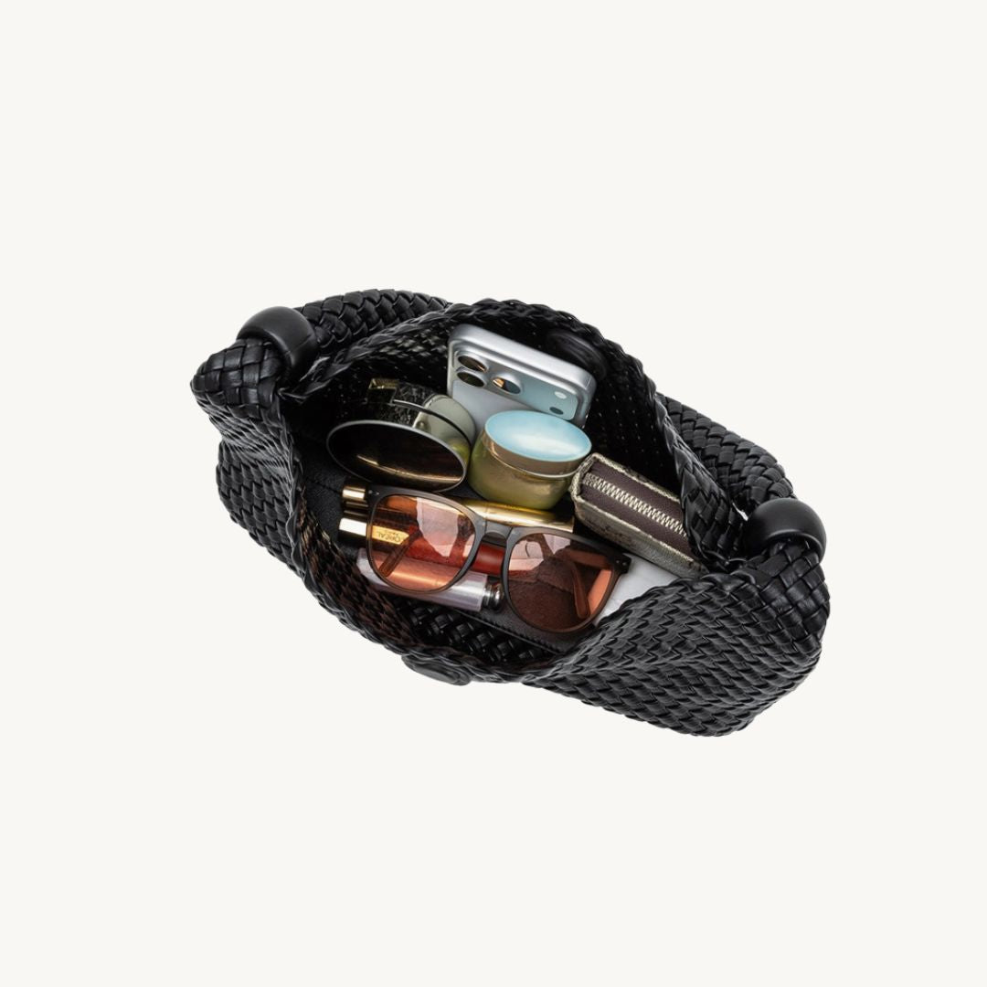 woven vegan leather handbag in black interior with items