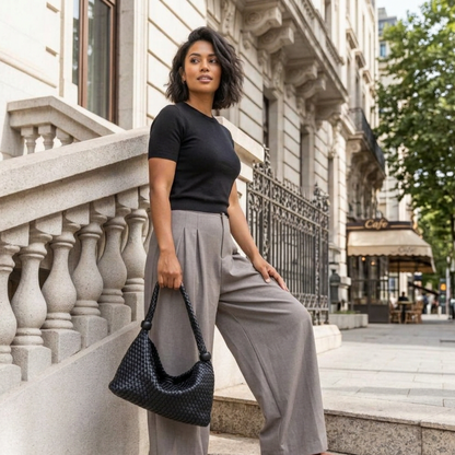 woven vegan leather handbag with a woman carrying it